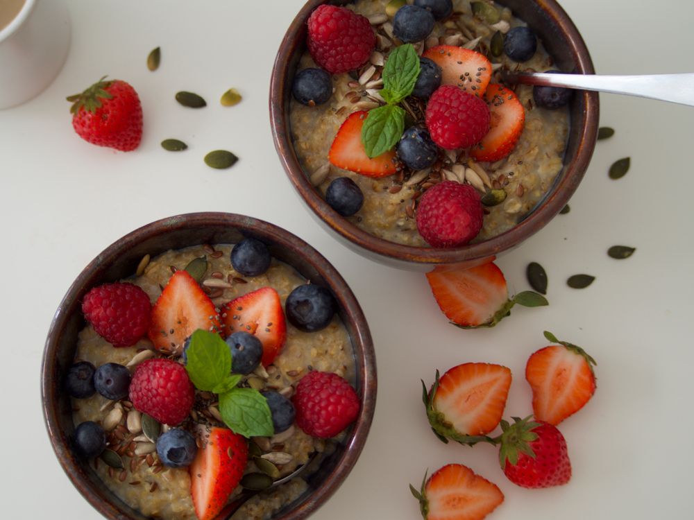 Oatmeal bowls topped with fresh berries