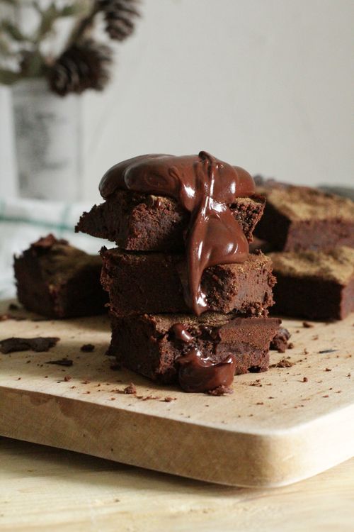 Chocolate brownies stacked on a board