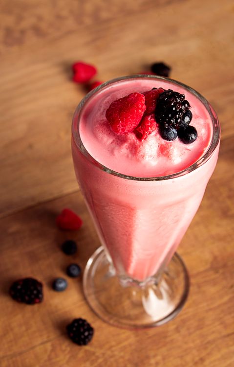 Berry smoothie topped with raspberries and blackberries
